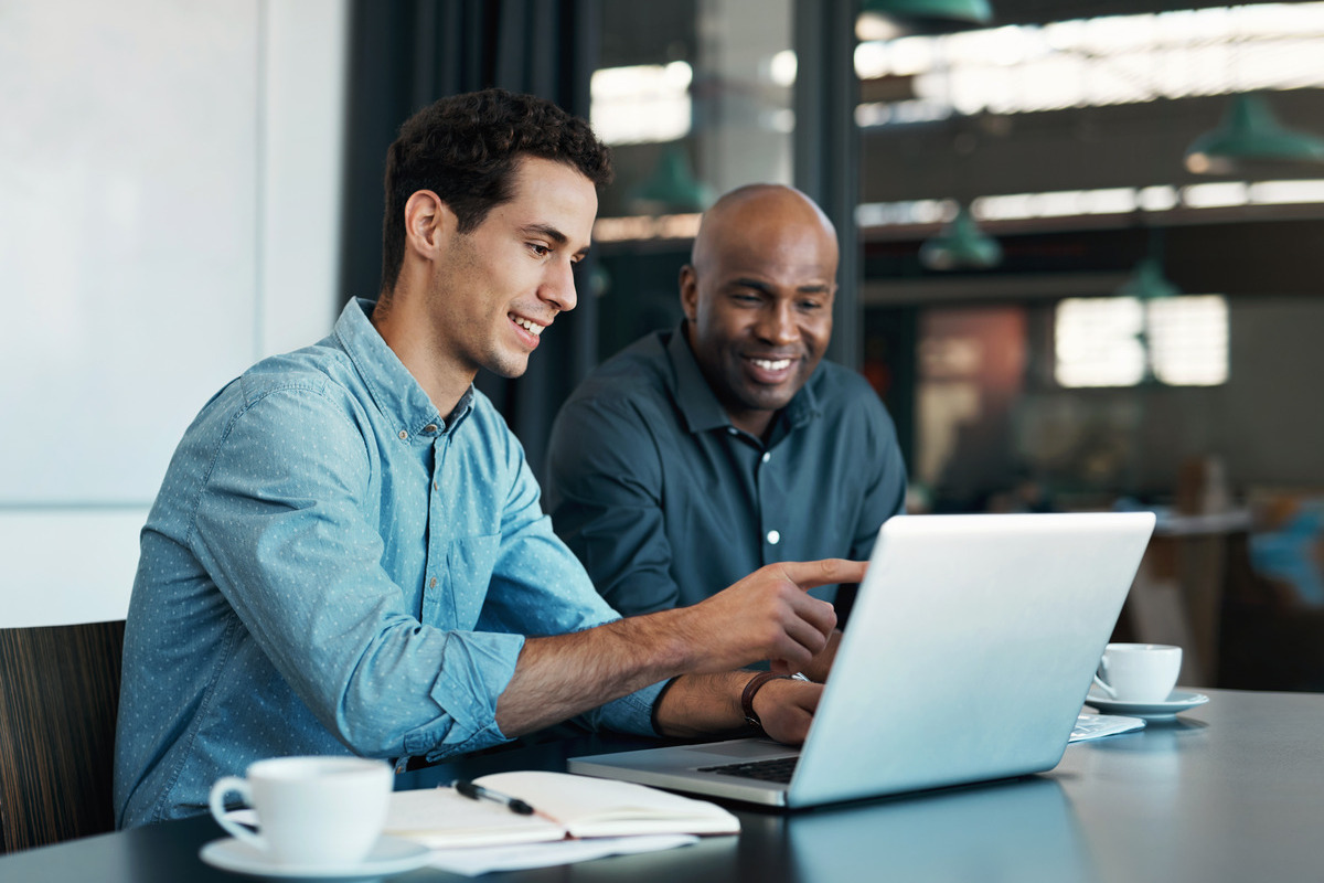 two people working on a laptop